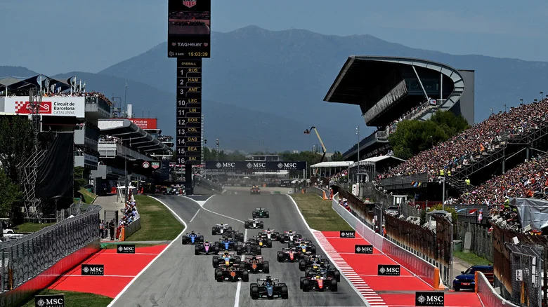 Racers speed down a straightaway  during F1's Barcelona Grand Prix