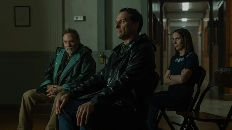 Tom, Patricia and Wyck stare at an unseen figure with apprehension during an episode of Widow's Bay