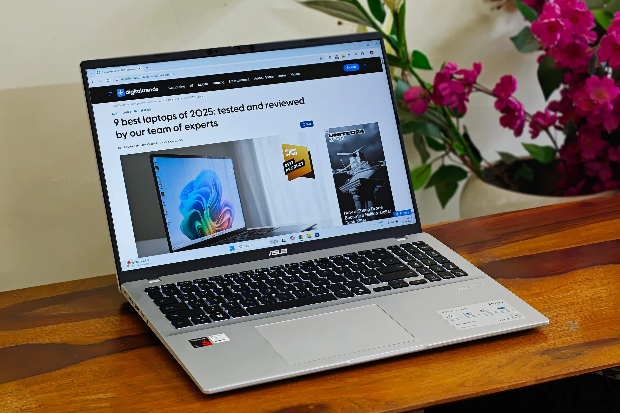 Asus Vivobook 16 X1607QA Copilot+ PC laptop with Qualcomm Snapdragon X ARM 64 chip on a wooden surface.
