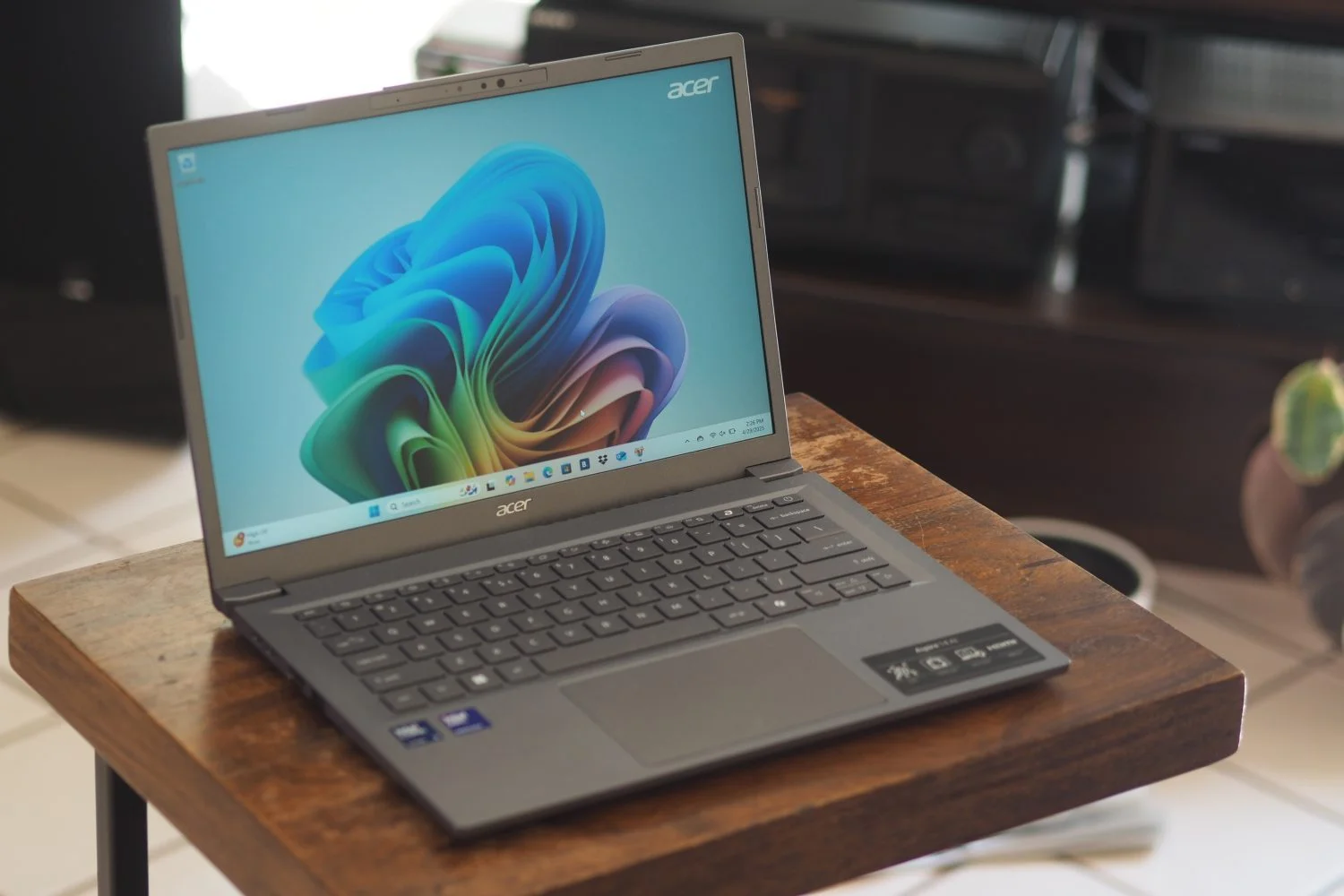 Acer Aspire 14 AI front angled view showing display and touchpad.