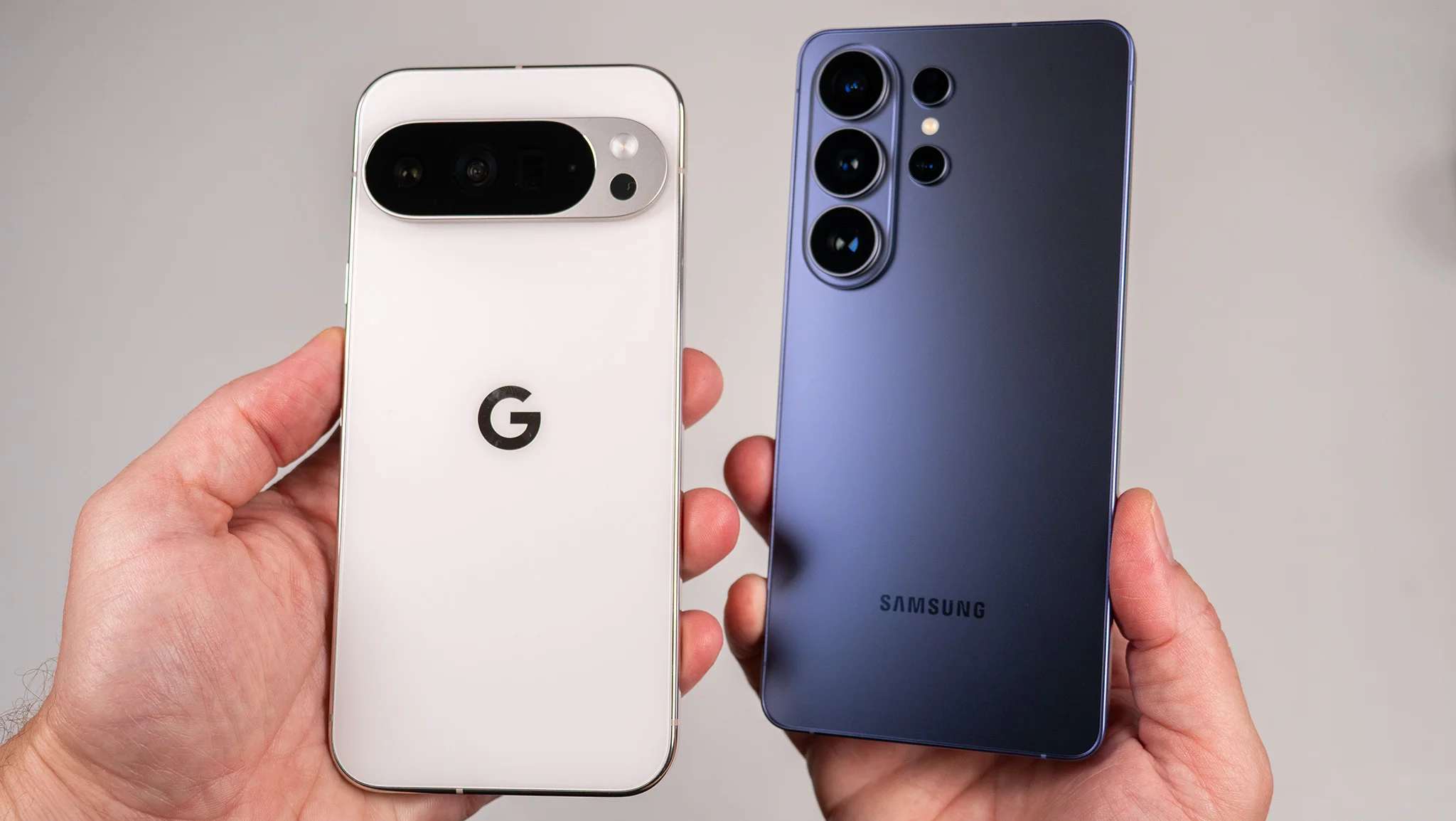 Comparing the back of the white Google Pixel 10 Pro XL with the blue Samsung Galaxy S26 Ultra