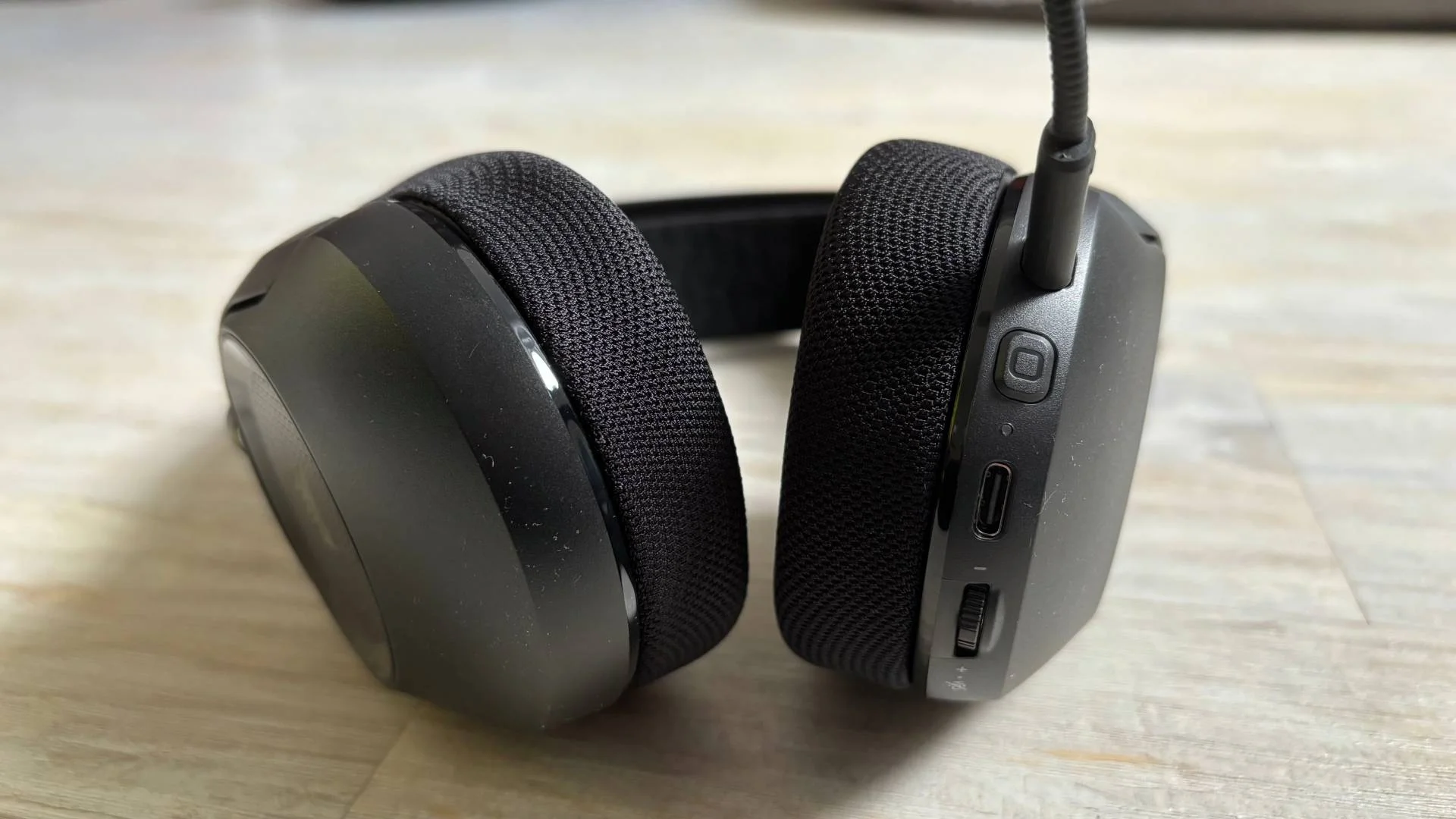 Close up of the Corsair HS35 v3 headset ear cups on a white hardwood background