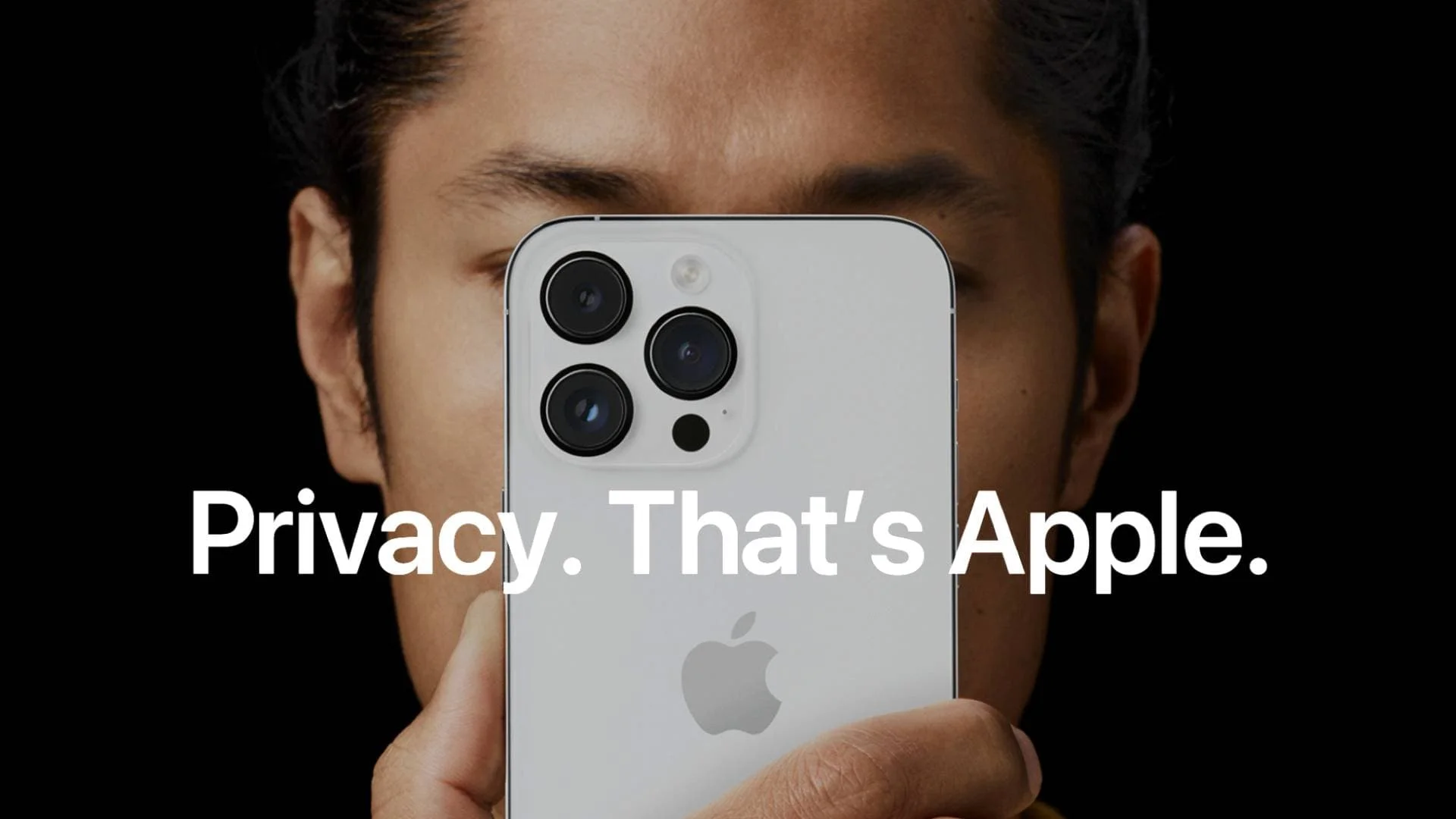A person holds a phone in front of their face.