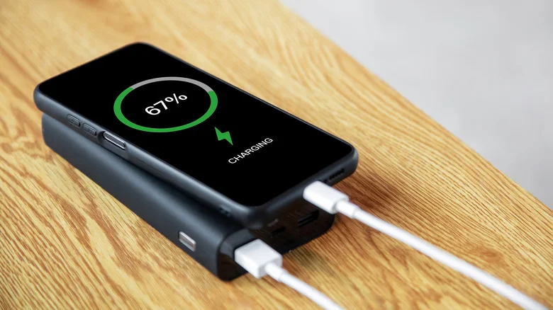 Phone showing "charging" on top of a power bank