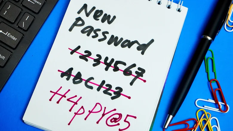 Various passwords written and crossed out on a notepad.