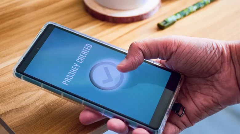 A "Passkey created" message shown on a phone.