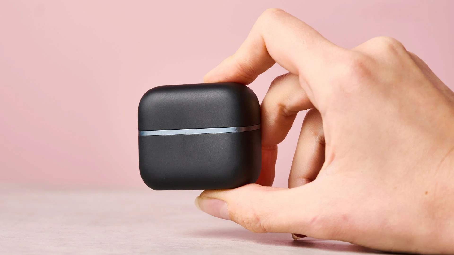 Woman holding Anker Soundcore AeroClip 2 charging case