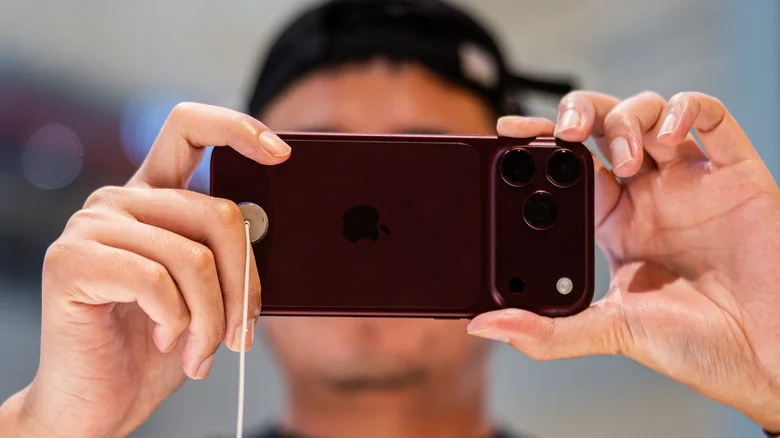 Snapping a photo with the burgundy iPhone 18 Pro.