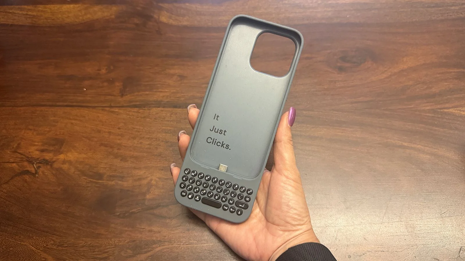 An original Clicks keyboard case in hand.